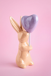 Bunny ceramic figure as Easter decor on pink background