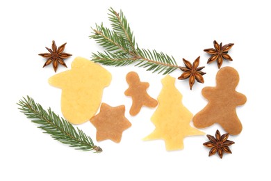 Unbaked Christmas cookies, anise and fir tree twigs on white background, top view