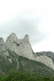 Picturesque landscape with high mountains under gloomy sky
