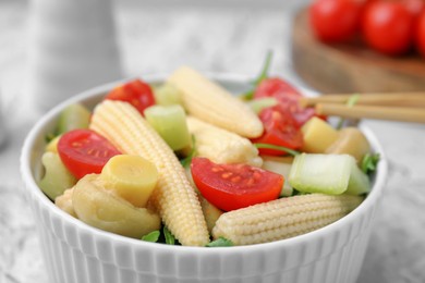 Photo of Tasty baby corn with vegetables and champignons on table, closeup