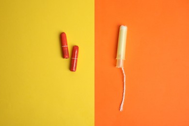 Regular and applicator tampons on color background, flat lay