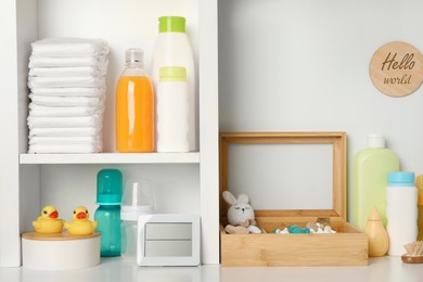 Photo of Toys and baby accessories on white rack