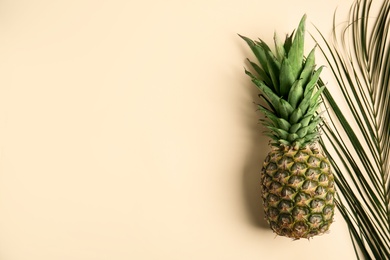 Photo of Fresh ripe juicy pineapple on beige background, top view. Space for text
