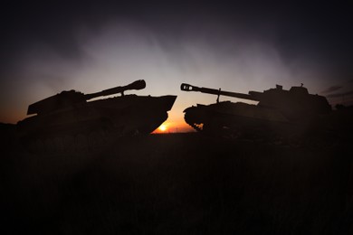 Image of Silhouettes of tanks on battlefield in night