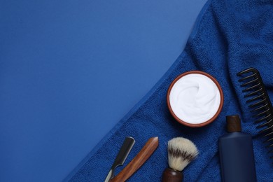 Composition with men's shaving accessories on blue background, flat lay. Space for text