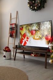 Modern TV and Christmas decor in room