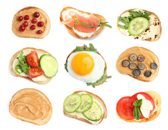 Set of toasted bread with different toppings on white background, top view 