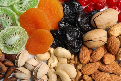 Different dried fruits and nuts as background, closeup
