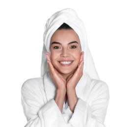 Beautiful young woman wearing bathrobe and towel on head against white background