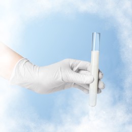 Image of Cryopreservation. Laboratory assistant holding test tube with sperm on light blue background, closeup. Frost effect