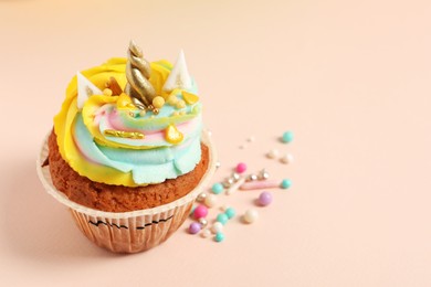 Cute sweet unicorn cupcake on beige background. Space for text