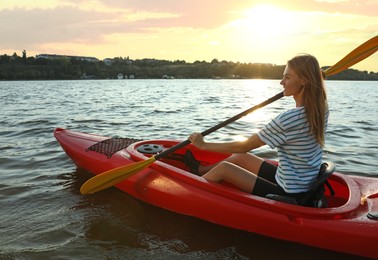Happy woman kayaking on river. Summer activity