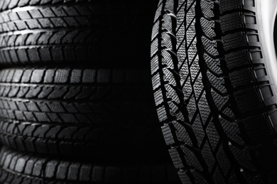 Winter tires as background, closeup. Car maintenance