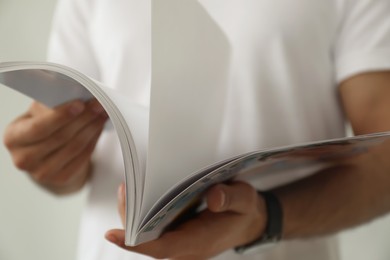 Closeup view of man reading healthy food magazine