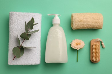 Flat lay composition with bottle of liquid soap on turquoise background