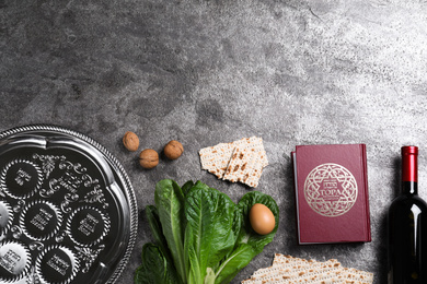 Flat lay composition with Passover Seder plate (keara) on grey table, space for text. Pesah celebration