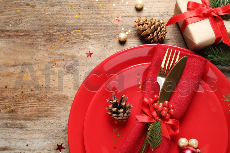 Beautiful Christmas table setting on wooden background, top view. Space for text