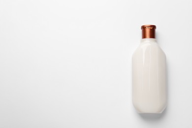 Bottle of shampoo on white background, top view. Space for text