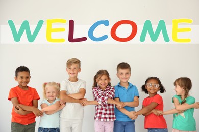 Word Welcome over little children holding hands on light background