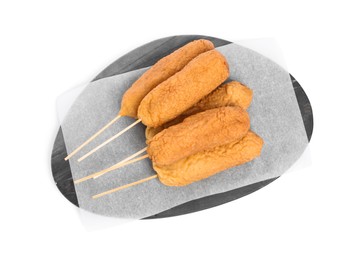Delicious deep fried corn dogs with marble board isolated on white, top view