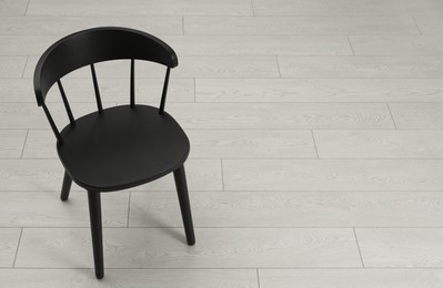 Stylish wooden chair on floor. Space for text