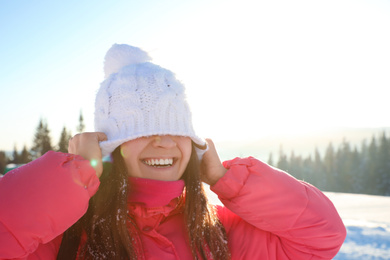 Young woman having fun outdoors on snowy winter day