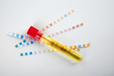Test tube with urine sample for analysis on white background, top view