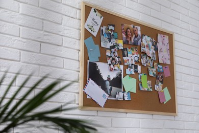 Vision board on white brick wall indoors
