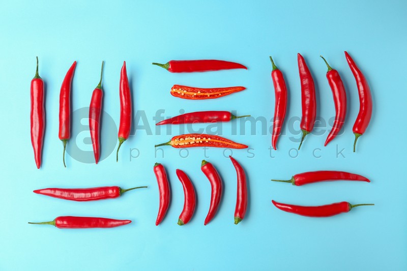 Flat lay composition with chili peppers on color background