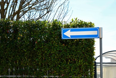Photo of Road sign One Way Traffic and green shrubbery outdoors