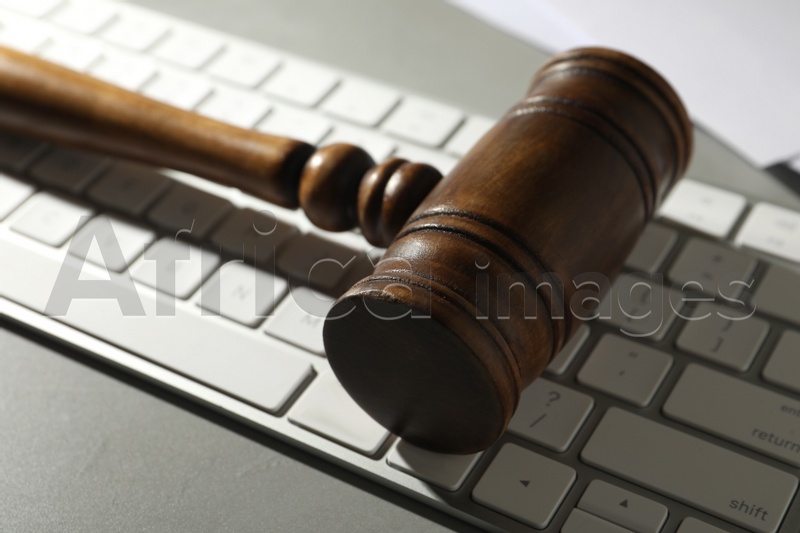 Gavel and computer keyboard on grey table. Cyber crime