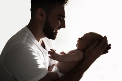 Father with his newborn baby on white background