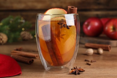 Hot mulled cider on wooden table, closeup