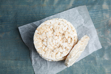 Stack of crunchy rice cakes on light blue wooden table, top view