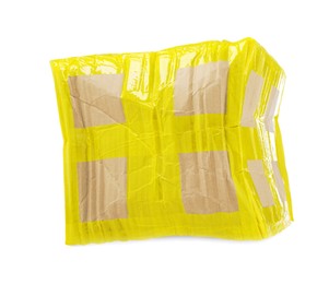 Photo of Crumpled cardboard parcel box with yellow sticky tape on white background