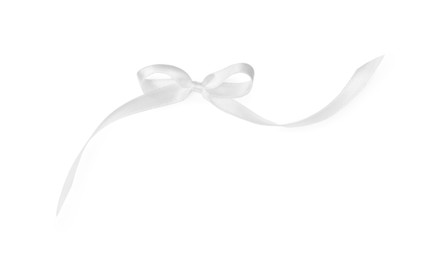 Satin ribbon tied in bow on white background, top view
