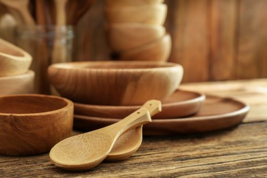 Photo of Many different wooden dishware and utensils on table, closeup