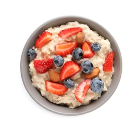 Tasty oatmeal porridge with blueberries, strawberries and almond nuts in bowl on white background, top view