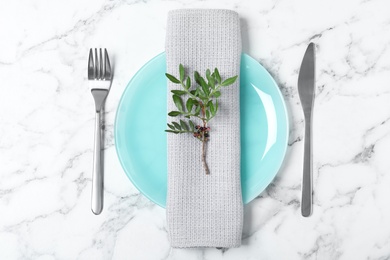 Beautiful table setting with napkin on marble background, top view