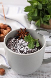 Photo of Tasty chocolate mug pie on white table. Microwave cake recipe
