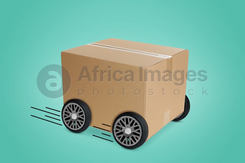 Image of Cardboard box on wheels against turquoise background. Order hurrying to client. Transportation and delivery service