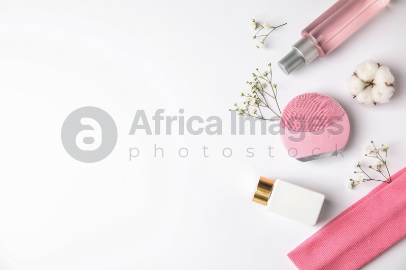 Photo of Composition with face cleansing brush on white background, top view. Cosmetic accessory