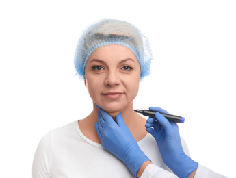 Surgeon with marker preparing woman for operation against white background. Double chin removal