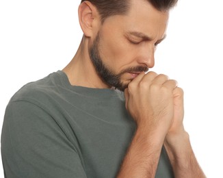 Man with clasped hands praying on white background, closeup