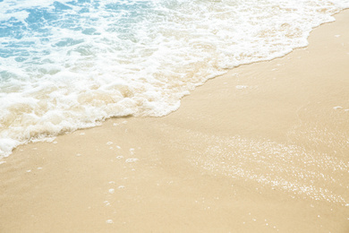 Sea waves rolling on beautiful sandy beach, closeup. Summer vacation