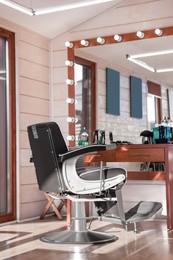 Stylish hairdresser's workplace with professional armchair in barbershop
