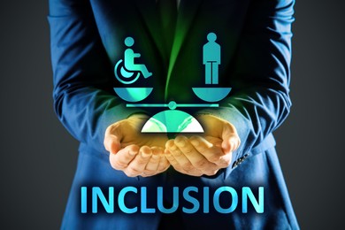 Concept of DEI - Diversity, Equality, Inclusion. Businessman showing virtual image of people, one with disability and scales on grey background, closeup