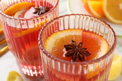 Photo of Glasses with aromatic punch drink on table, closeup