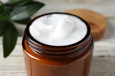 Jar of face cream on white table, closeup