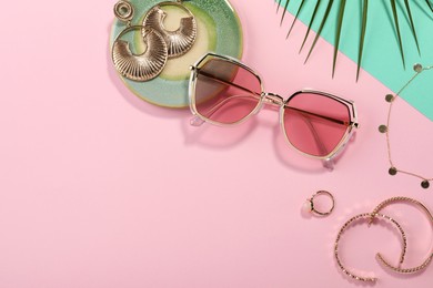 Photo of Stylish sunglasses and jewelry on color background, flat lay. Space for text